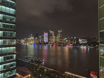 Illuminated city buildings at waterfront