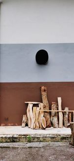 Stack of logs against wall