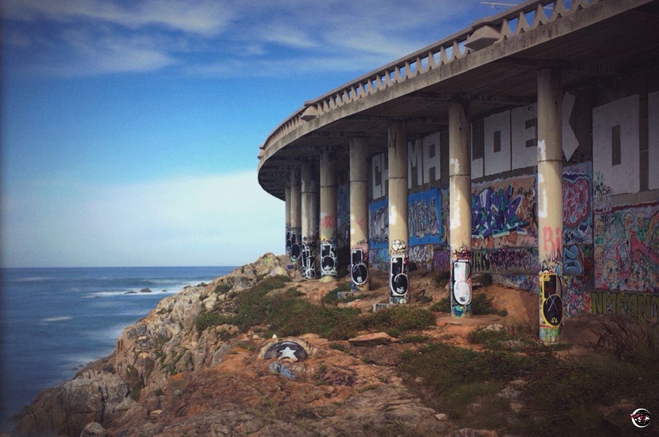 sea, sky, architecture, horizon over water, outdoors, built structure, building exterior, day, beach, water, no people