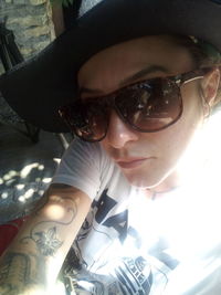 Close-up portrait of young woman wearing sunglasses