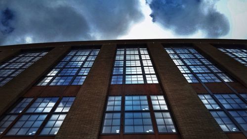 Low angle view of building against cloudy sky