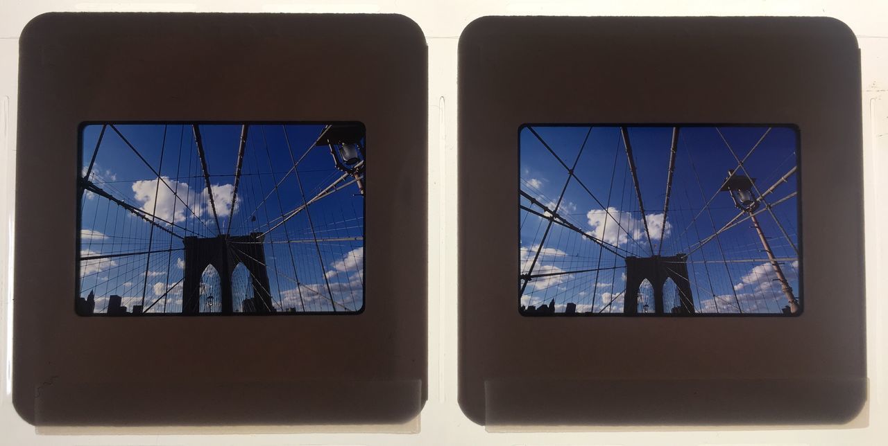 LOW ANGLE VIEW OF TELEPHONE POLE AGAINST SKY SEEN THROUGH WINDOW