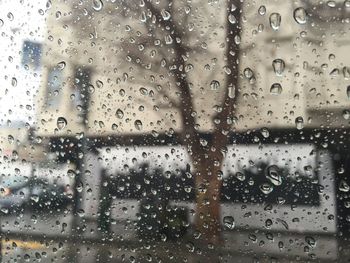 Full frame shot of wet glass window in rainy season