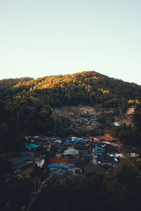 High angle view of houses and trees against clear sky