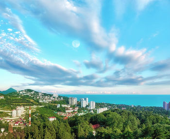 High angle view of trees and buildings against sky