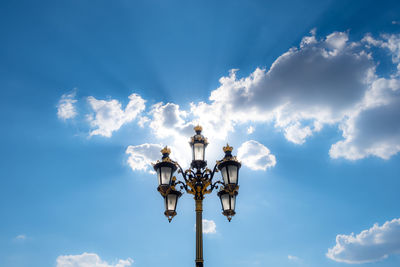 Low angle view of street light against blue sky