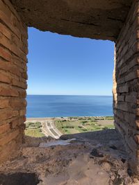 Scenic view of beach against clear blue sky