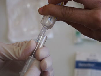 Close-up of doctor filling syringe at hospital