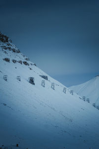 People skiing on snow covered landscape