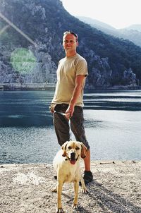 Full length of man with dog on water