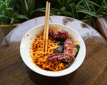 Korean hot spicy fried chicken served with ramen instant noodles, stir fried noodle.