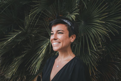 Close-up of woman standing by plant