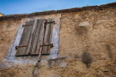 Low angle view of weathered wall