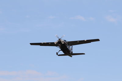 Low angle view of airplane against blue sky