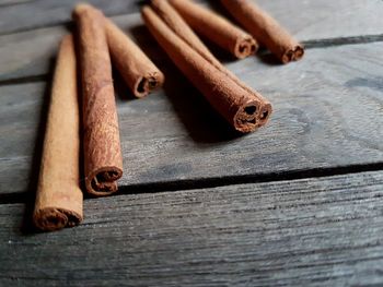 High angle view of cinnamons on wooden table