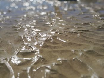 High angle view of wet sand at beach