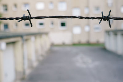 Close-up of barbed wire in city