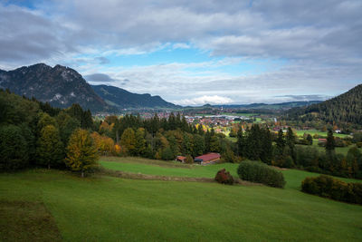 Scenic view of field and mountains against sky