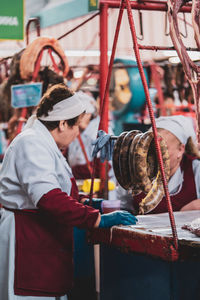 Side view of people looking at market