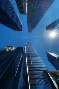Low angle view of modern buildings against clear blue sky