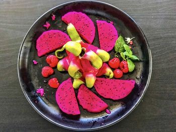 High angle view of chopped fruits in bowl on table