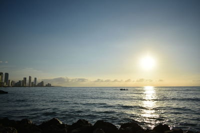 View of city at waterfront during sunset