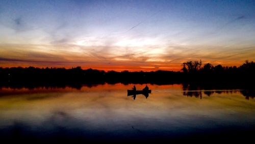 Scenic view of lake at sunset