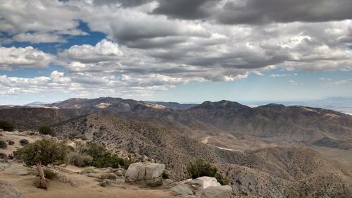 Scenic view of mountains against cloudy sky