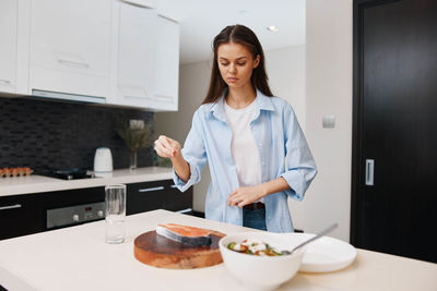 Portrait of young woman sitting at home