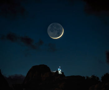 Low angle view of moon against sky at night