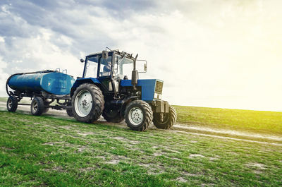 Tractor on field against sky