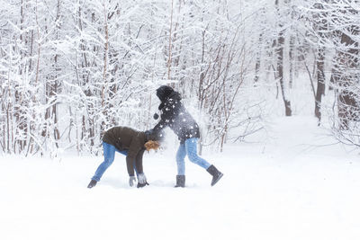 Full length of woman standing on snow covered land