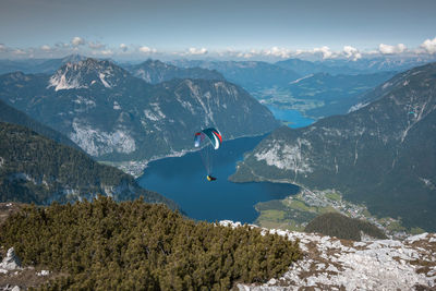 High angle view of person paragliding on mountain against sky