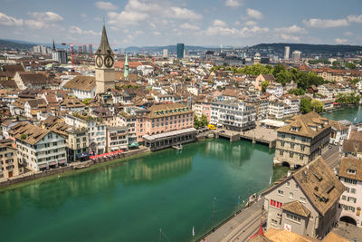 High angle view of buildings by sea against sky