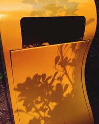 Close-up of yellow car against sky