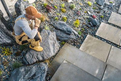 High angle view of woman sitting on rock