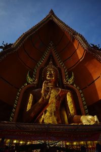 Statue of temple against building