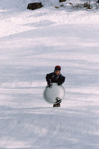 Boy with sledge walking on snow