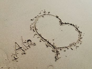 High angle view of heart shape on sand at beach