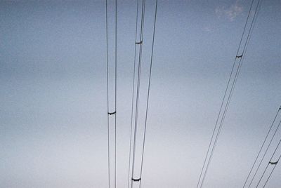 Low angle view of cables against clear sky