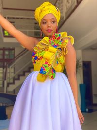 Portrait of a smiling young woman donning a tailor-made dress