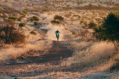 Man cycling on dirt road