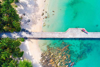 Directly above shot of concrete jetty at tropical beach