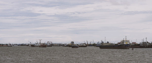 Sailboats on sea against sky