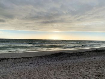 Scenic view of beach against sky during sunset