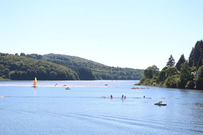 People enjoying in river against clear sky at la salvetat-sur-agout