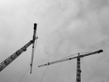 Low angle view of crane against sky