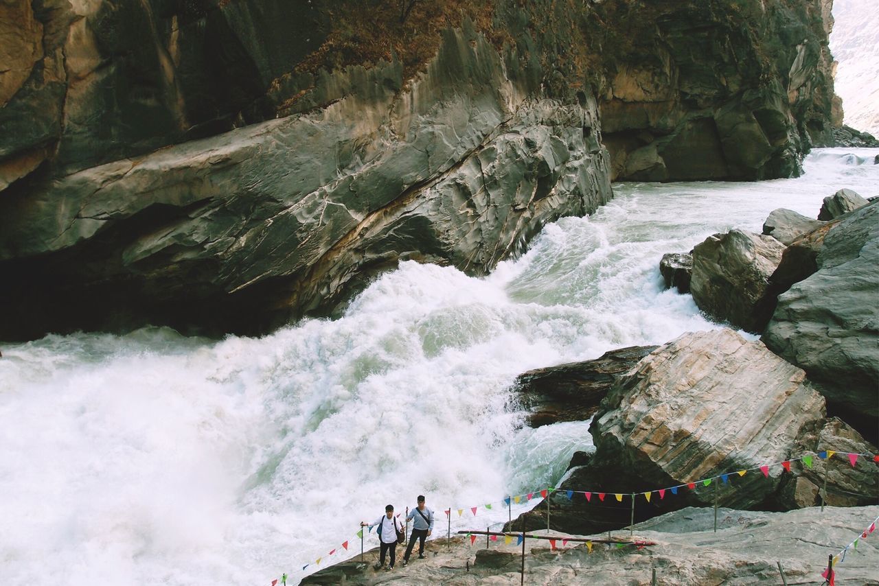 water, rock - object, sea, leisure activity, motion, lifestyles, surf, men, nature, high angle view, beauty in nature, rock formation, scenics, wave, person, vacations, day, rock, outdoors