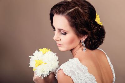 Portrait of beautiful woman against white background