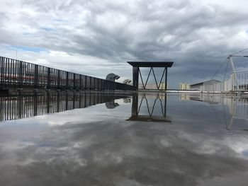 Pier over water against sky